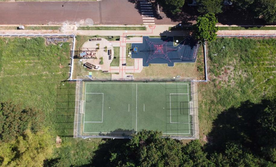 Meu Campinho em Maringa. O espaço tem um campo de futebol de grama sintética, playground com piso emborrachado e com iluminação, bicicletários, bebedouro, mesas de jogos, floreiras e lixeiras -